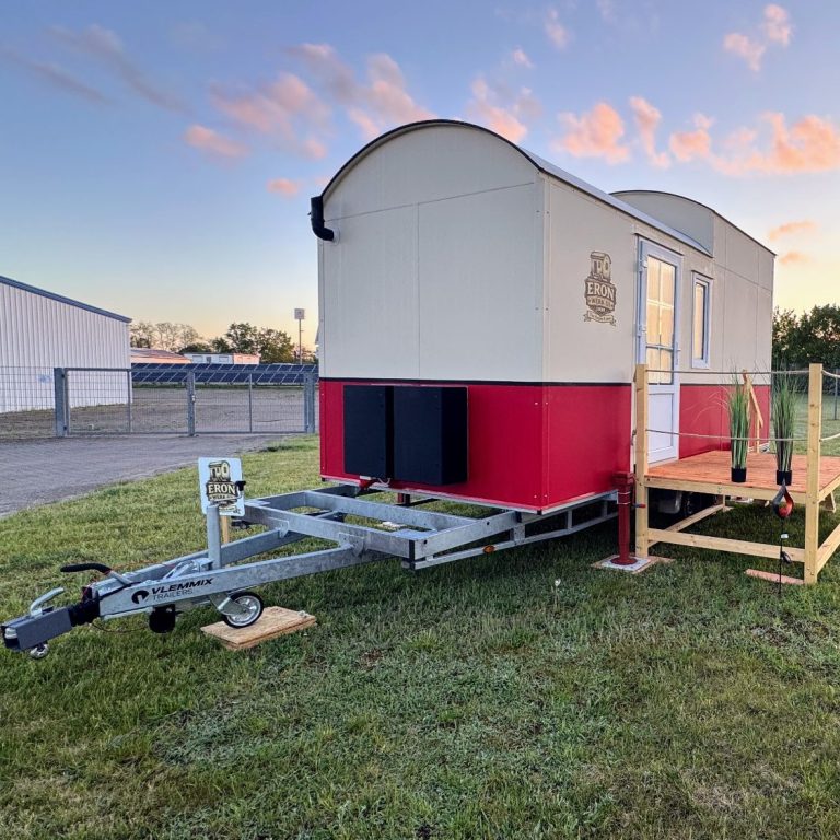 Tiny House mit rotem Streifen auf PKW Trailer.